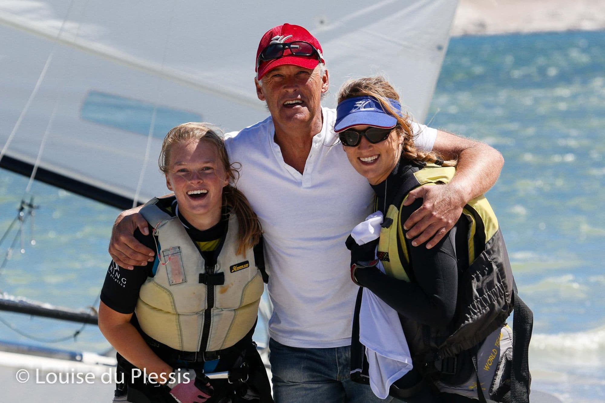 Jaco du Plessis with his daughters Shannon and Megan, in life jackets beside a Hobie